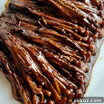close up of black bean enoki mushrooms