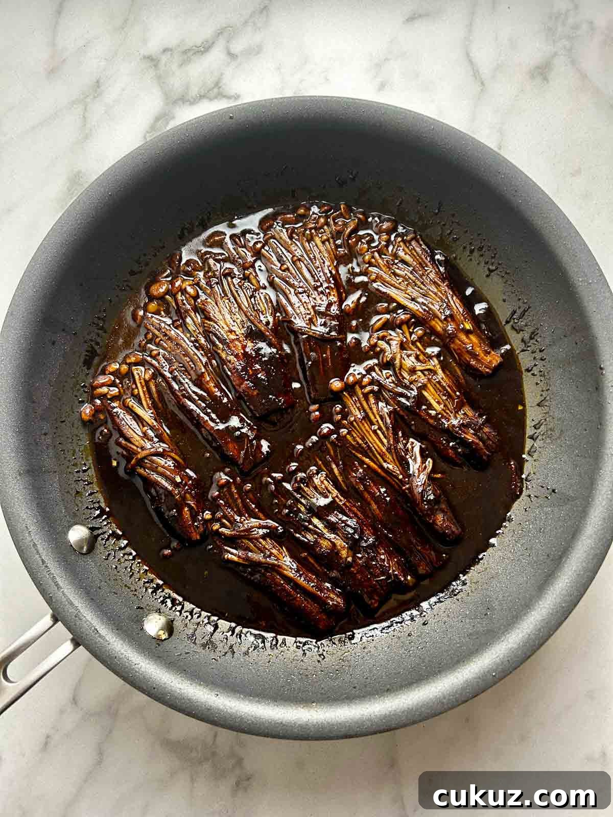 enoki mushrooms simmering in black bean sauce