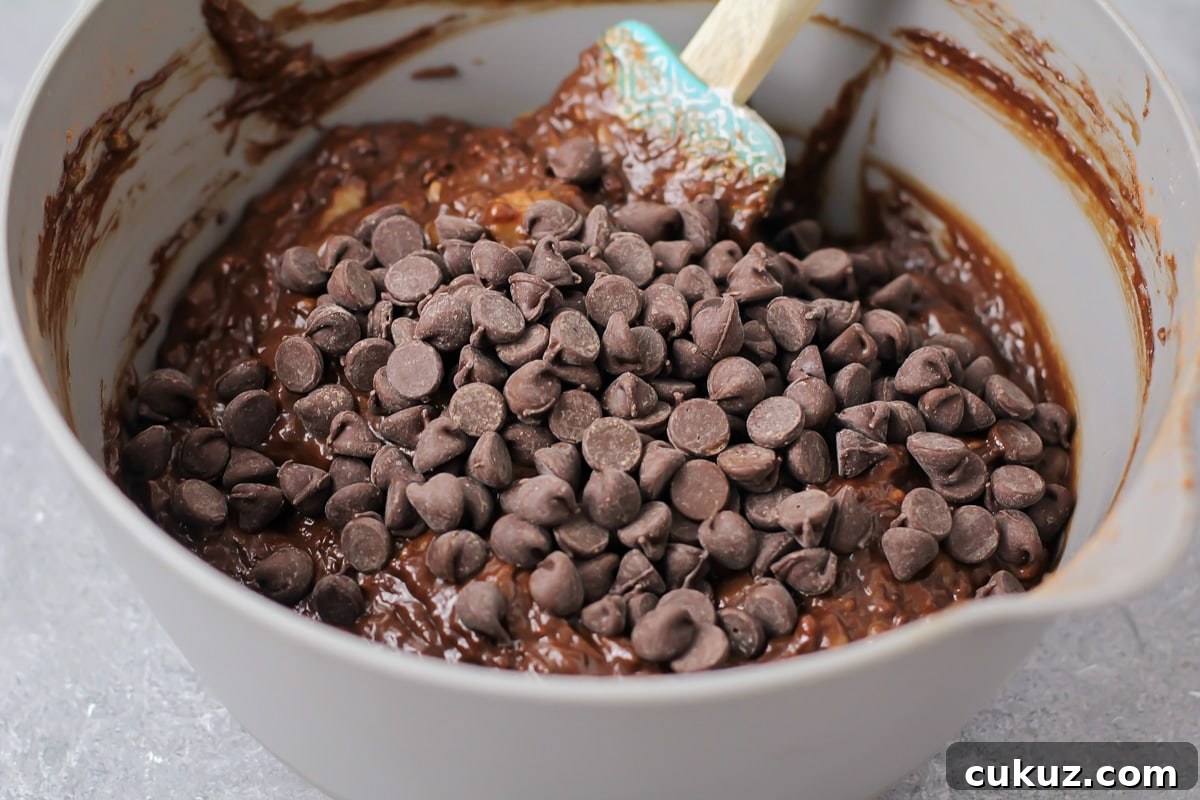 Wet ingredients in bowl for chocolate banana bread recipe.