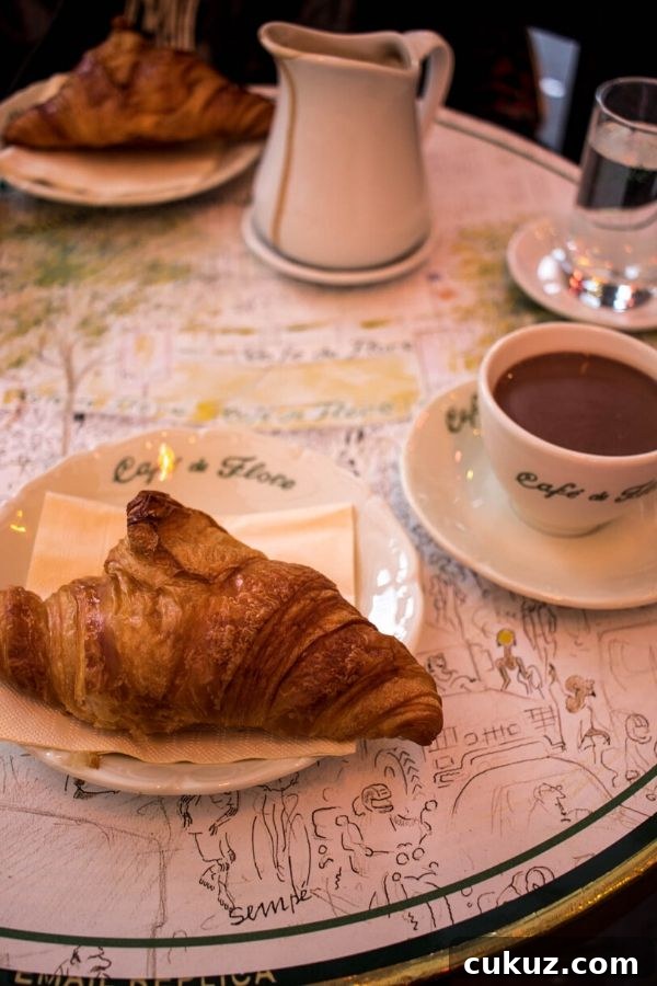 Ultimate Guide to Paris’s Top Hot Chocolate Spots 4 a croissant and a cup of hot chocolate at Cafe de Flore Paris