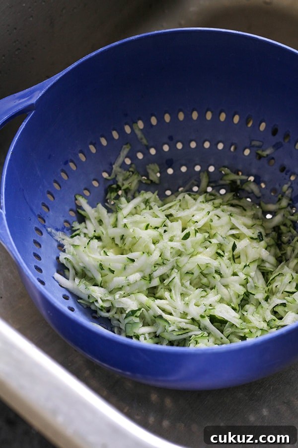 grated zucchini in a colander.