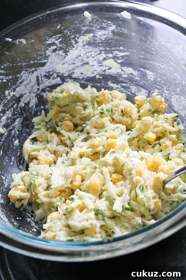 fritter ingredients mixed together in a glass mixing bowl.