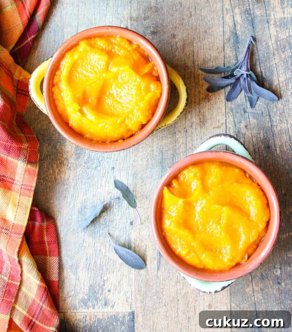 Creamy Roasted Butternut Squash Mash Recipe 5 Two bowls of squash on a table with sage leaves