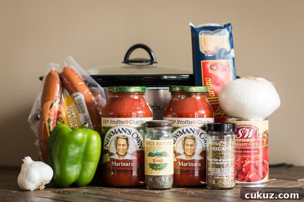 kielbasa, jars of marinara, seasonings, spaghetti, diced tomatoes, onion and bell pepper.