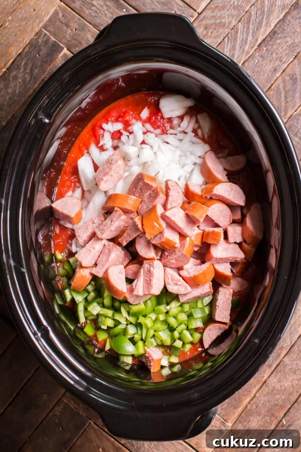 kielbasa, bell pepper, onion, and marinara sauce in a slow cooker.