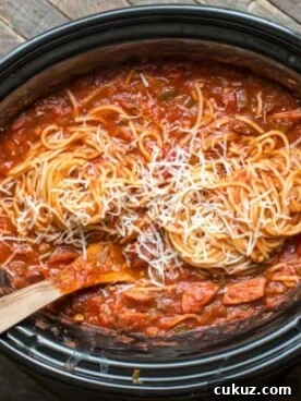 Spaghetti and kielbasa and sauce in a slow cooker