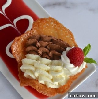 white and dark chocolate mousse in a tulip cup on decorated plate