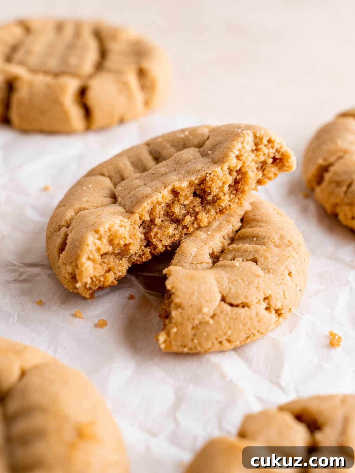 Two halves of a peanut butter cookie stacked on top of each other.