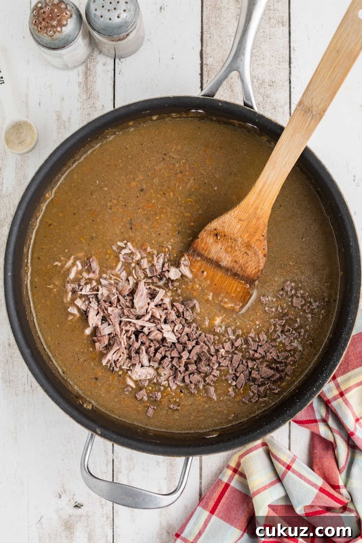 Meat added to a large skillet.