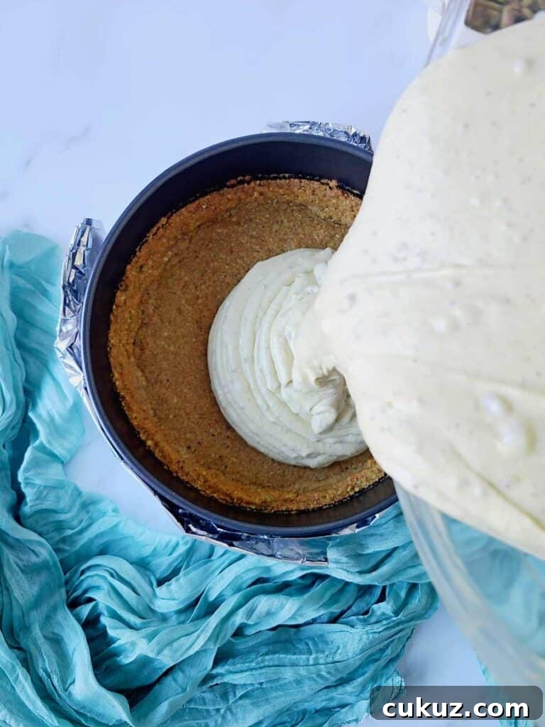 Pouring cheesecake batter into a pan