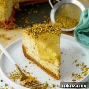 FI pistachio cheesecake slice on white plate