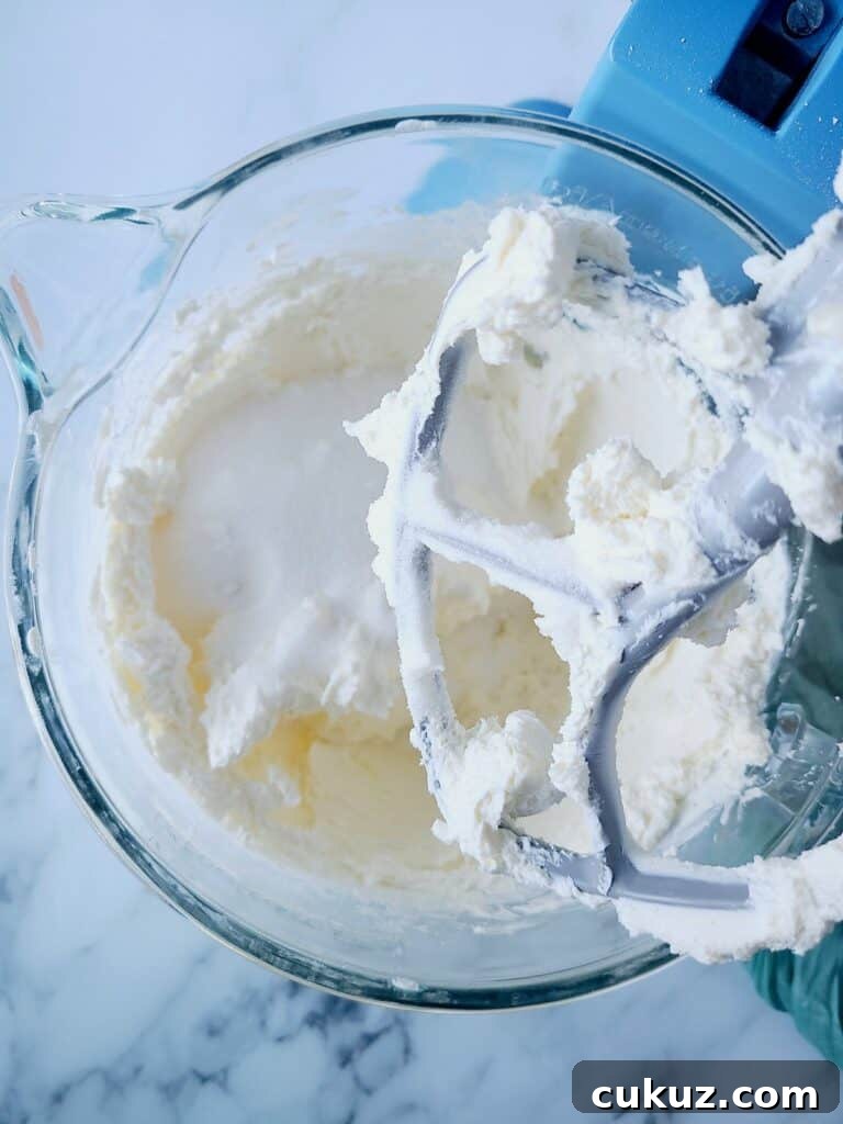 Mixing cream cheese with sugar