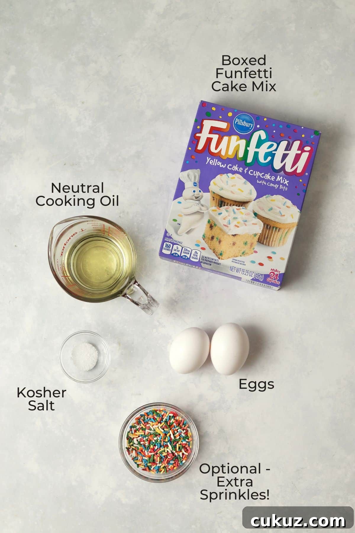 3-Ingredient Funfetti Cake Mix Cookies Recipe 3 Boxed funfetti cake mix, oil in a measuring cup, two eggs, and small bowls with salt and sprinkles.