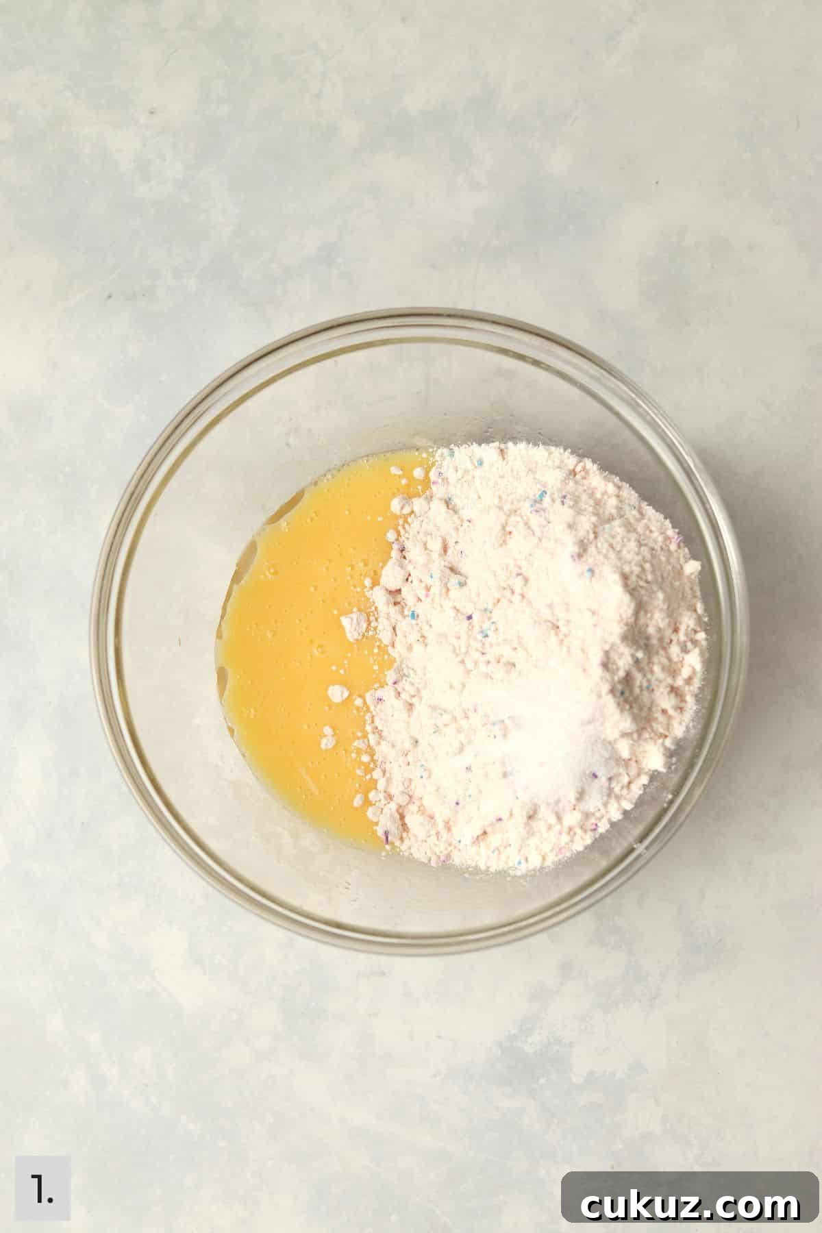 3-Ingredient Funfetti Cake Mix Cookies Recipe 4 Eggs and oil mixed together with funfetti cake mix being added.