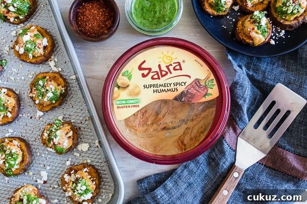 These pesto hummus sweet potato bites are the perfect bite size appetizer. Sumac roasted sweet potato rounds topped with spicy hummus, drizzled with spinach pesto and sprinkled with crumbled feta - how delicious is that! 