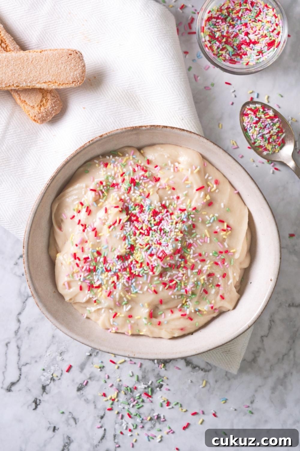 Quick 4-Ingredient Dunkaroo Dip Ready in 5 Minutes 10 An overhead view of homemade Dunkaroo dip topped with rainbow sprinkles.