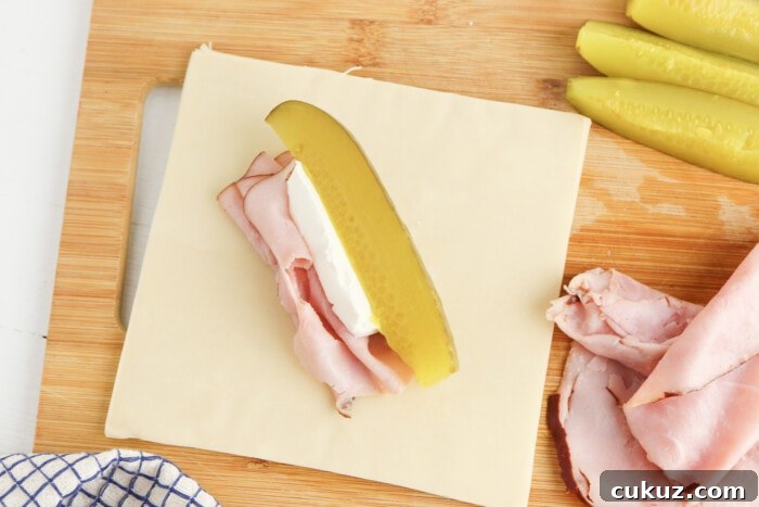 Crispy Pickle Egg Rolls with Tangy Dipping Sauce 4 ham, pickle and cream cheese on the wrapper