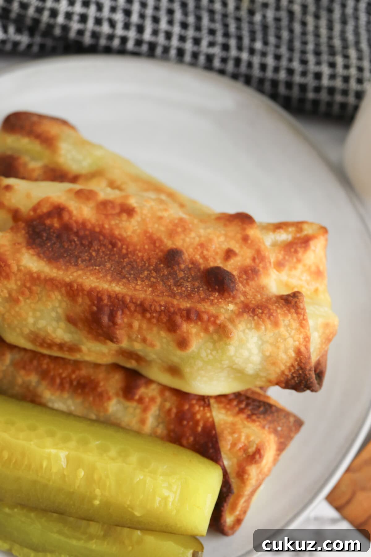 Try the delicious air fryer pickle egg rolls with ham and cream cheese pickle egg rolls on a white plate