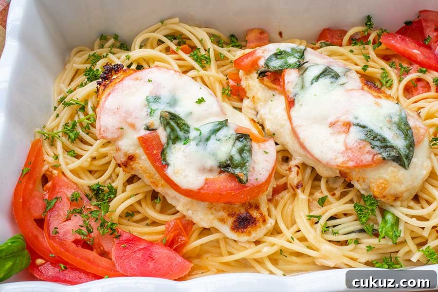 chicken parmesan dinner served over noodles