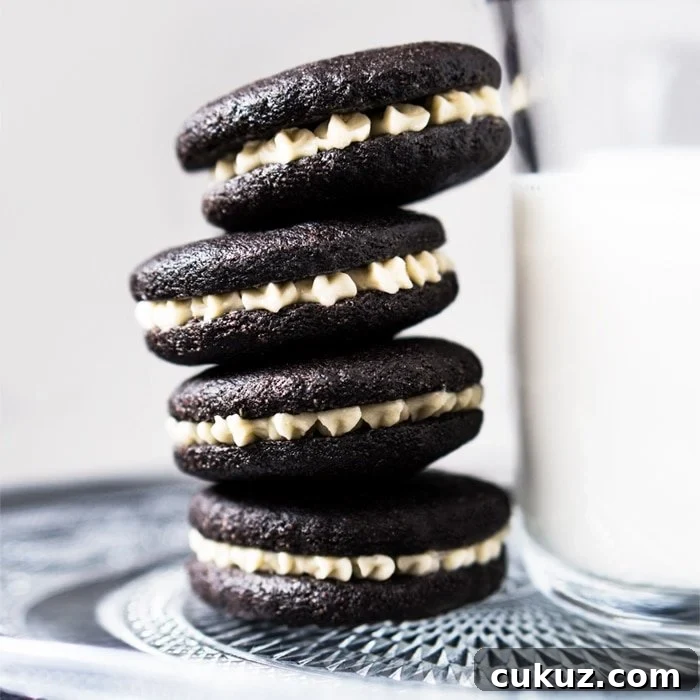 Gluten free & keto oreos stacked with a glass of milk