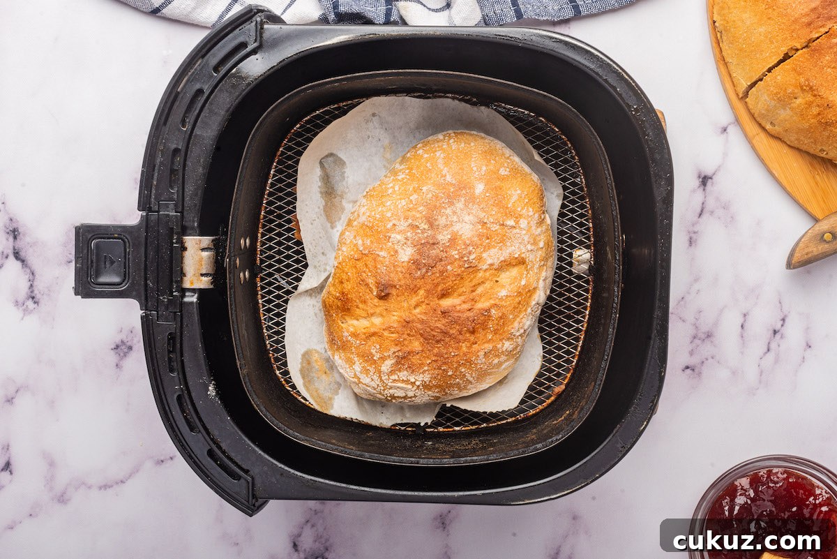 top down view of the bread loaf inside the air fryer basket.