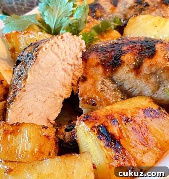 Chicken breast cut in half on the serving platter exposing tender juicy grilled chicken breasts.