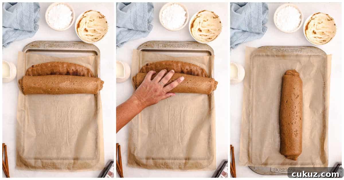 cinnamon roll cookie dough being rolled into a log