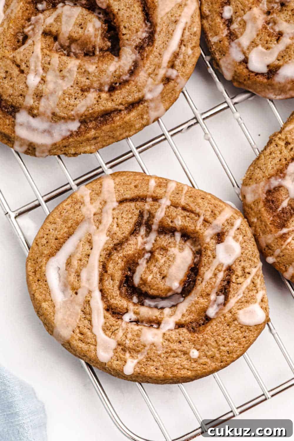 Cinnamon roll cookies on a wire rack