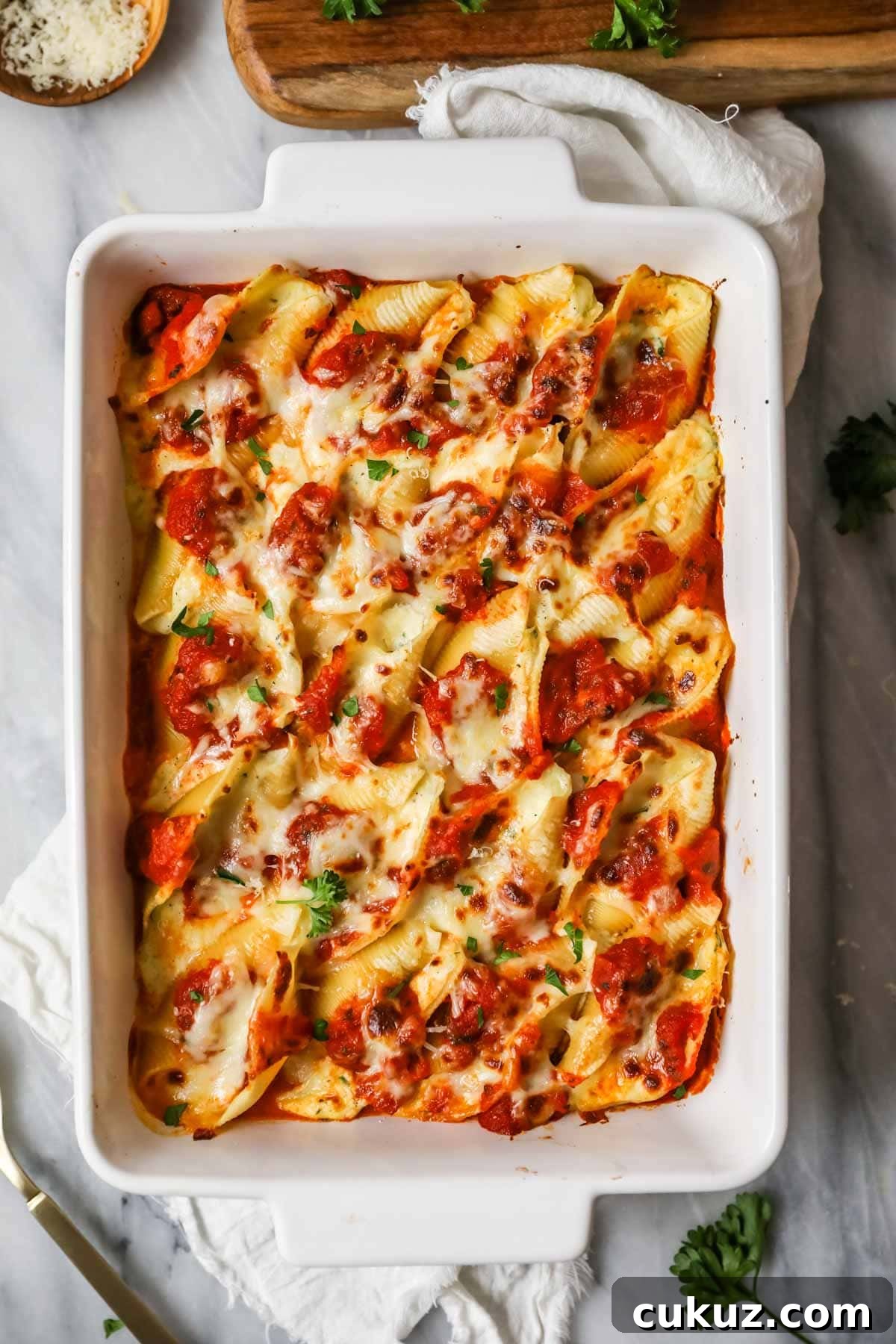 Overhead view of a pan of stuffed shells after baking.