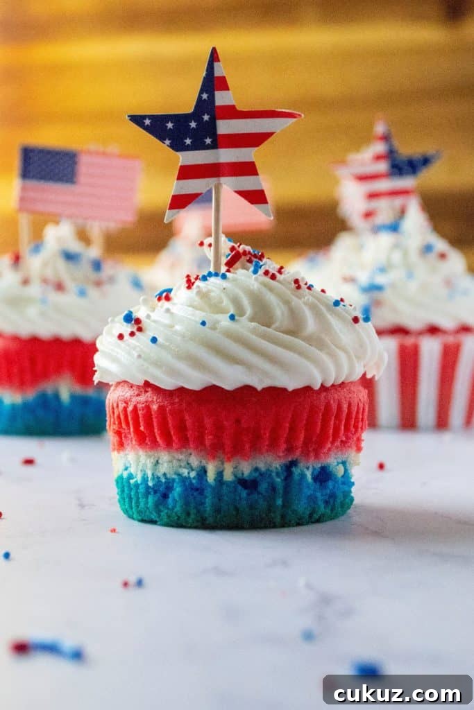 Red White and Blue Patriotic Cupcakes are the perfect Fourth of July Cupcakes to show off your American pride. Red, white and blue layered cupcakes topped with homemade buttercream frosting, these Red, White and Blue Patriotic Cupcakes will be the star of every Fourth of July dessert table.
