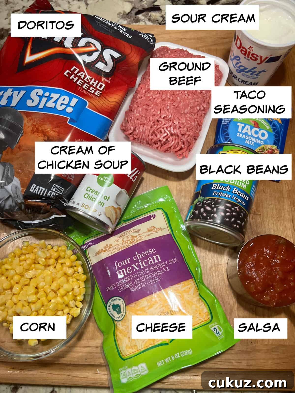 ingredients:doritos, ground beef, taco seasoning, black beans, soup, corn, salsa, and cheese.