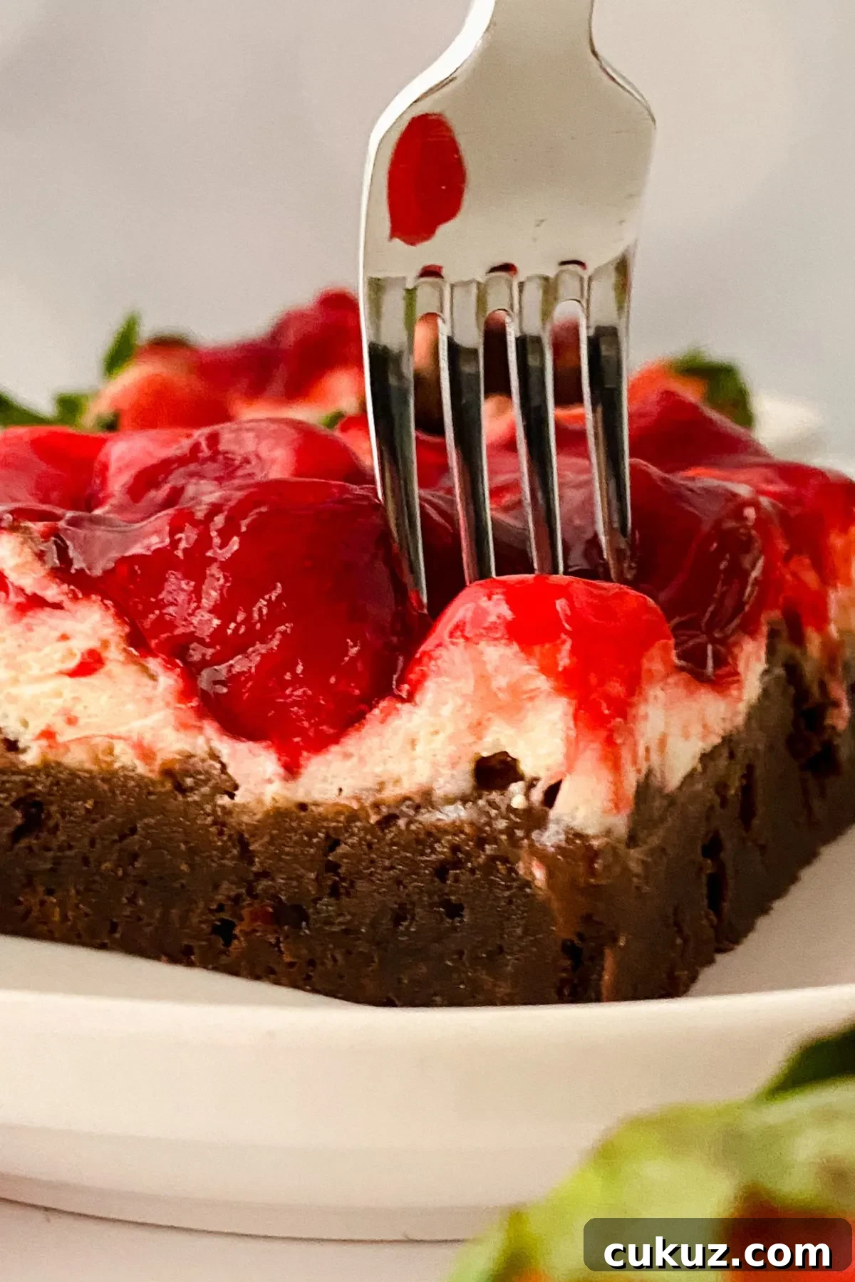 A fork in a Strawberry Cheesecake Brownie.