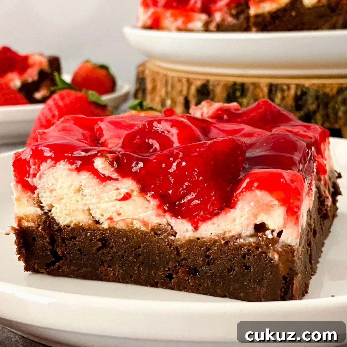 Close up looking at a slice of gluten free strawberry cheesecake brownie.