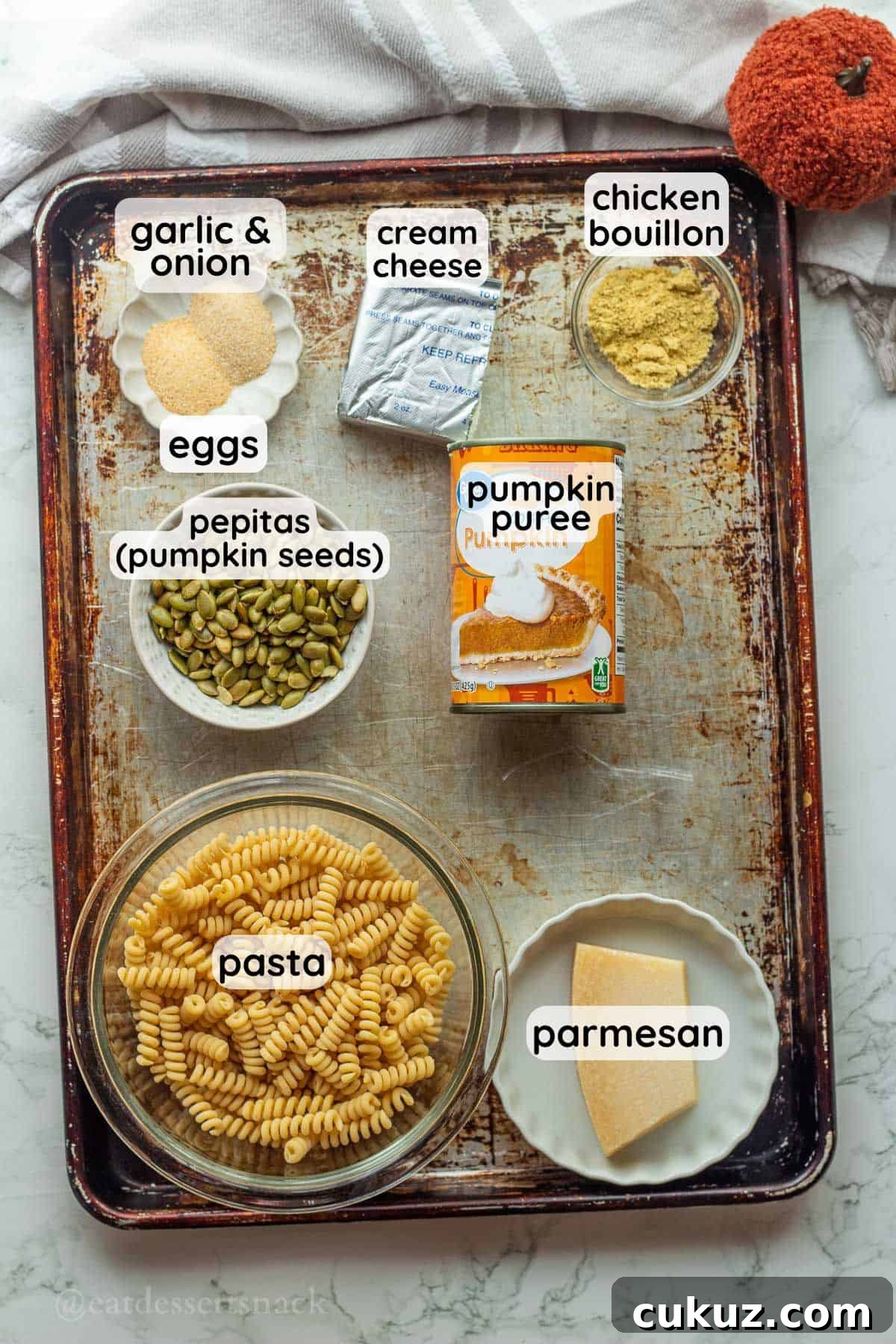 Labeled ingredients for pumpkin pasta sauce on metal pan.