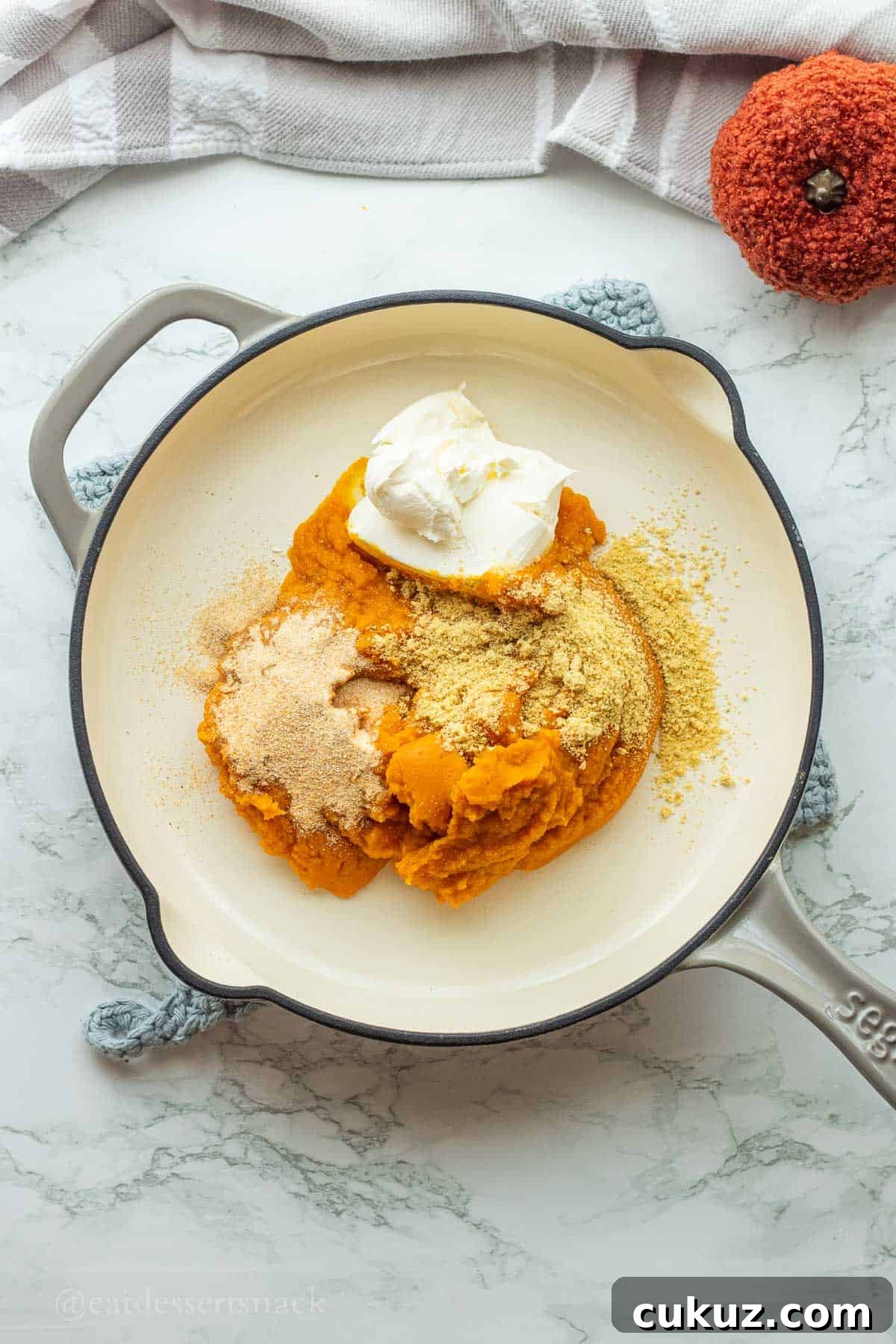 Pumpkin puree, cream cheese, and seasonings in pan.