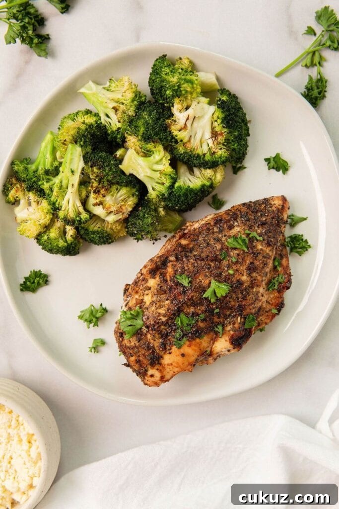 balsamic feta stuffed chicken on a plate with roasted broccoli
