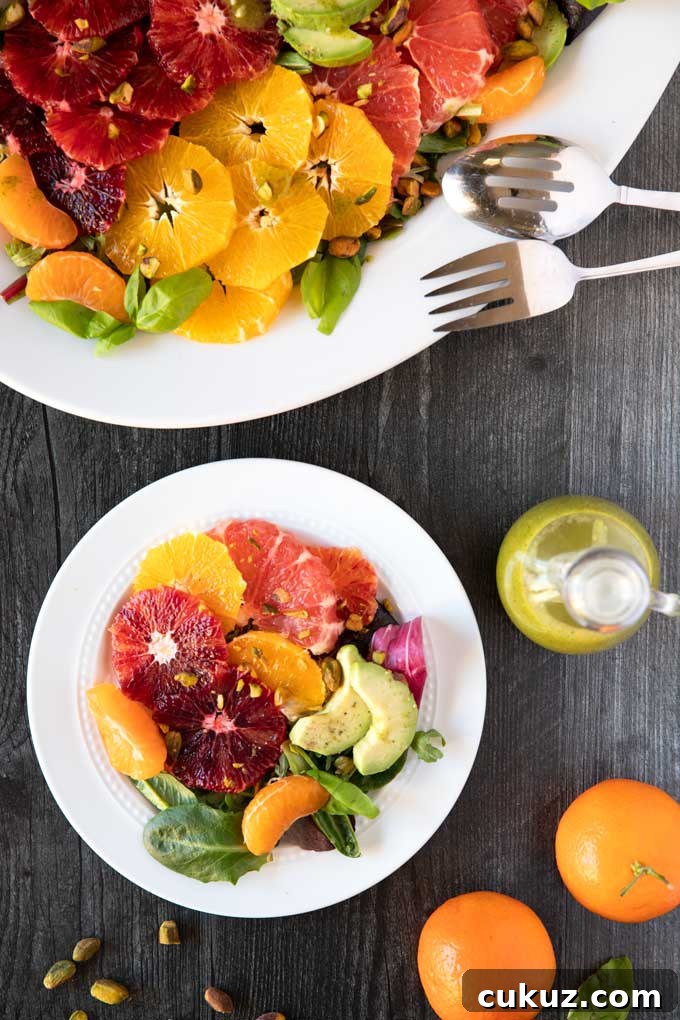 Citrus Fruit Salad with the best basil dressing on a white plate.