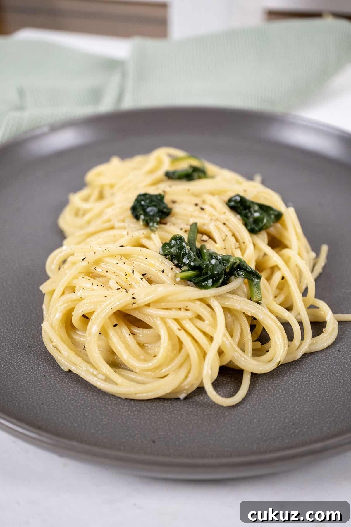 Lemon spinach pasta served on a plate.