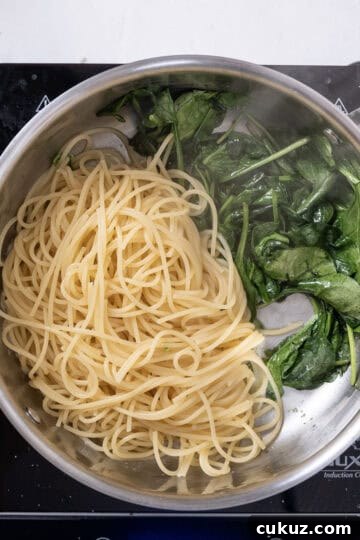 Pasta added to spinach.