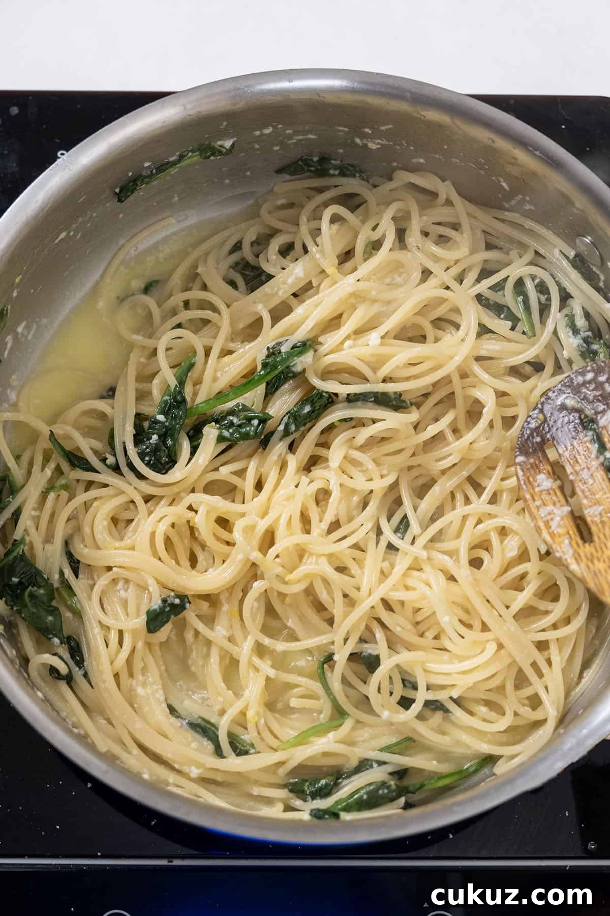 Pecorino and lemon mixture added to pasta.