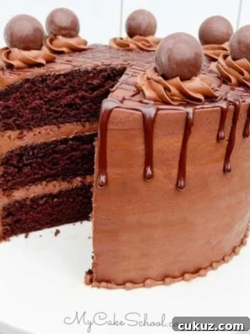 Chocolate Truffle Cake, sliced, on a pedestal.