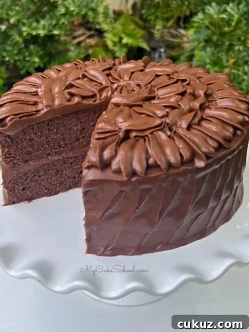 Sliced Brownie Cake on a white cake pedestal.