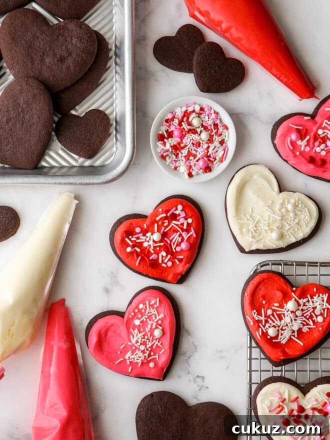 frosted sugar cookies with piping bags and sprinkles