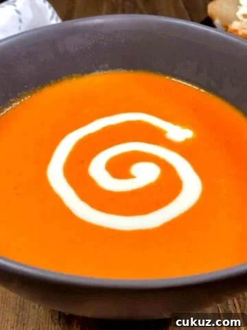 tomato orange soup with a cream swirl