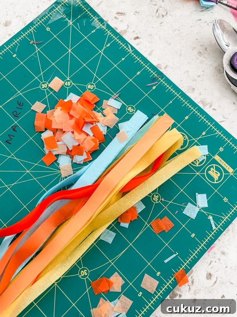 Strips of paper being used to make the confetti squares