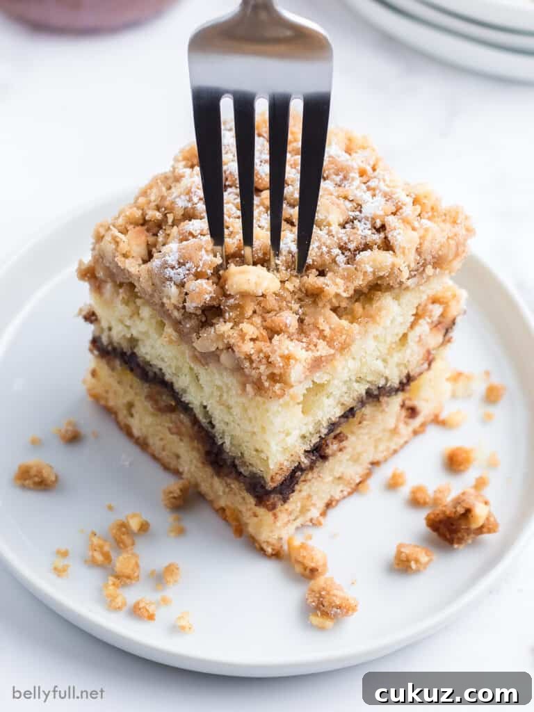 fork inserted into a slice of coffee cake