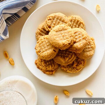 almond flour peanut butter cookies on plate next to glass of milk