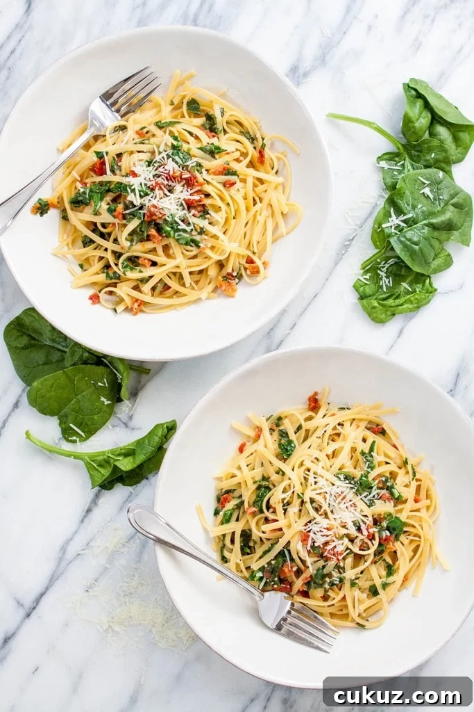 two bowls of spinach and sun dried tomato pasta