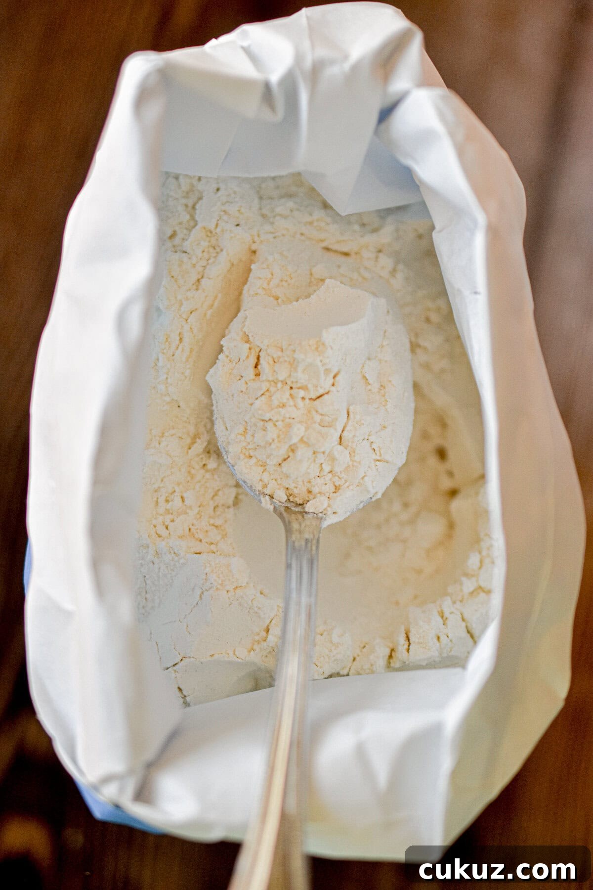 Bread Flour vs. All-Purpose Flour: Key Differences You Should Know 5 A spoon is in a bag of bread flour.