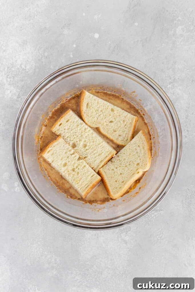 Bread slices added to the french toast mixture.